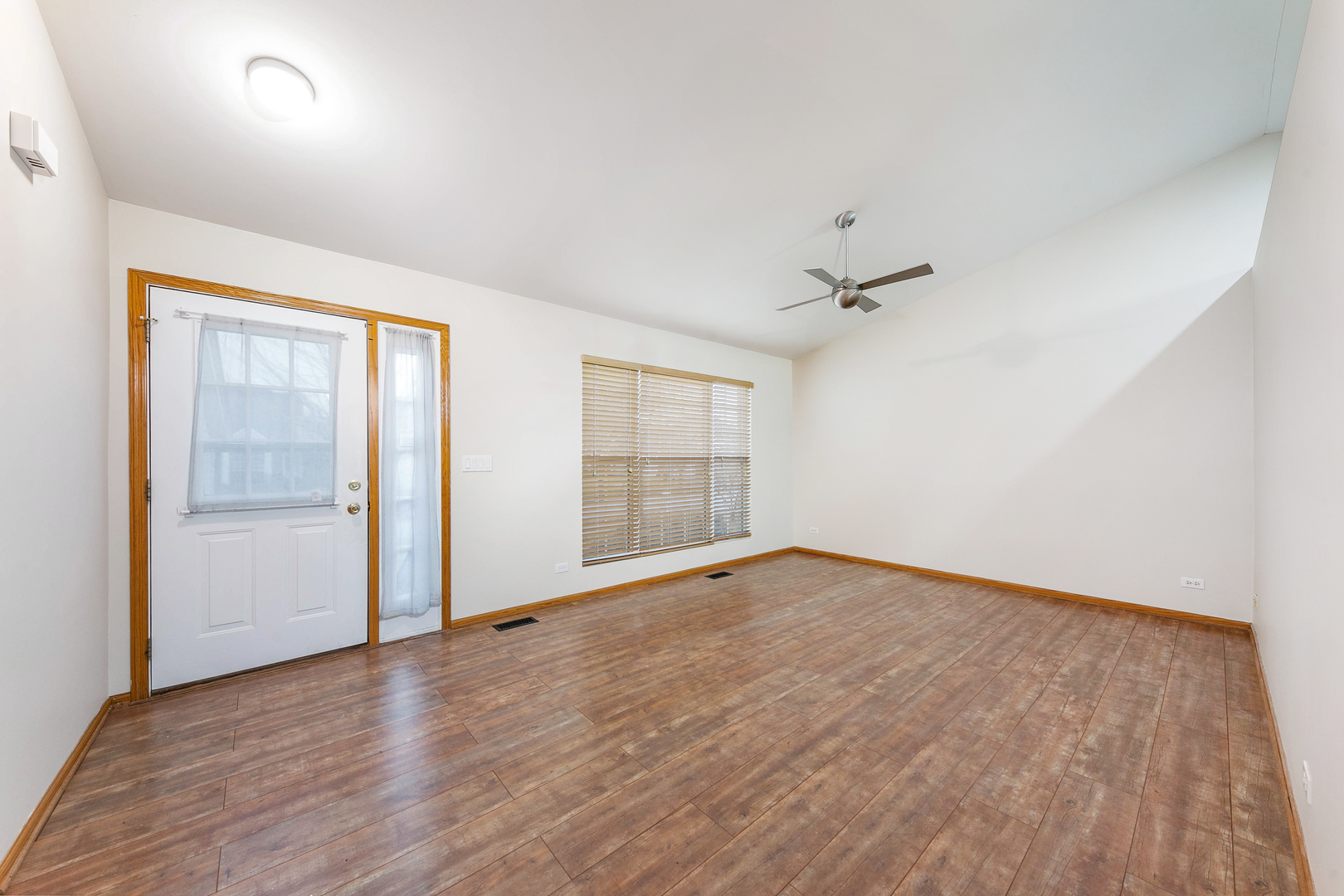 448 Bluebird Drive Bolingbrook, IL 60440 - Photo 2 of 20 an empty room with wooden floor and windows