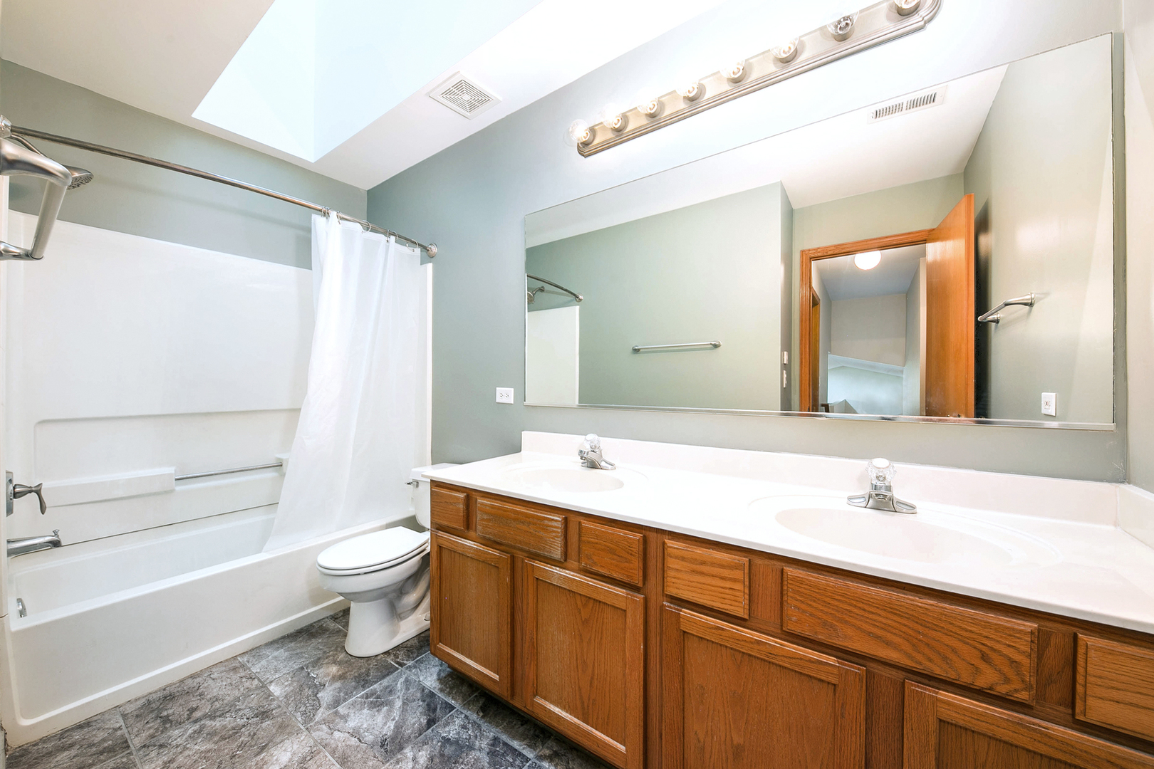 448 Bluebird Drive Bolingbrook, IL 60440 - Photo 14 of 20 a bathroom with a sink toilet a mirror and bathtub