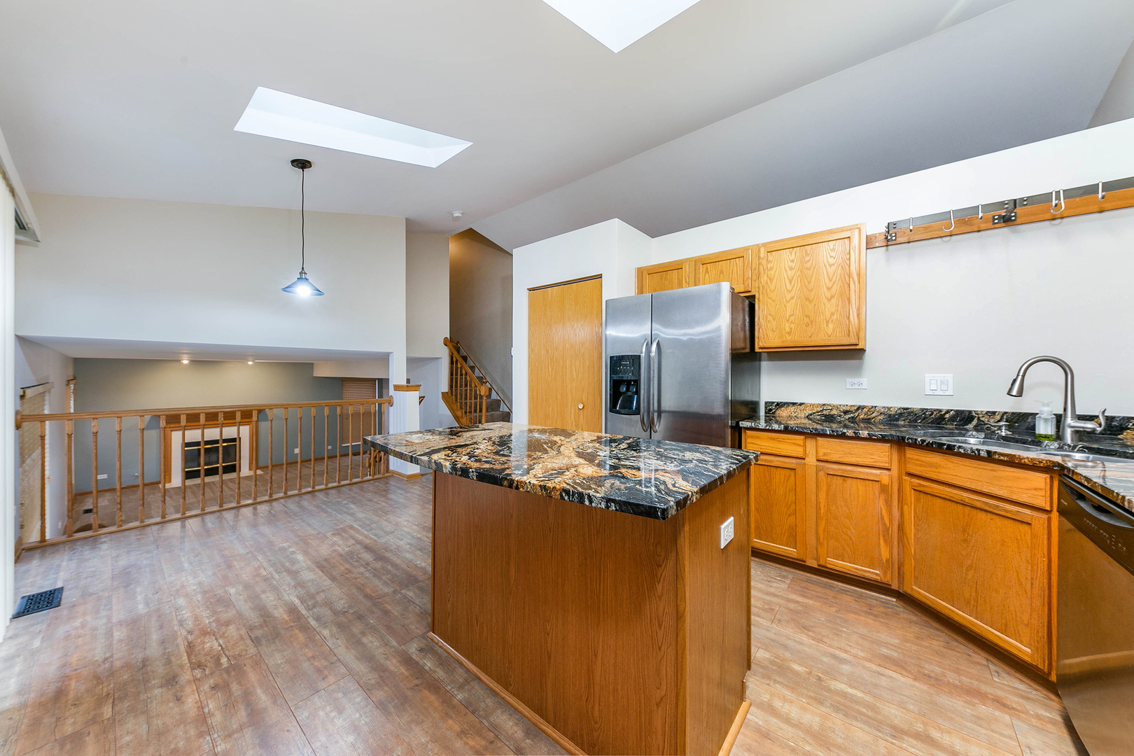 448 Bluebird Drive Bolingbrook, IL 60440 - Photo 7 of 20 a kitchen with stainless steel appliances granite countertop wooden floors and sink