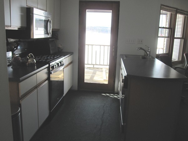 105 Kimball Road Amesbury, MA 01913 - Photo 12 of 20 a kitchen with kitchen island a window appliances and cabinets