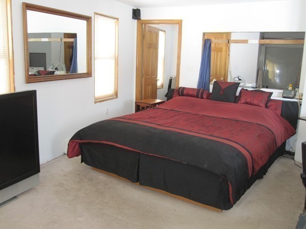 105 Kimball Road Amesbury, MA 01913 - Photo 10 of 20 a bedroom with a bed lamp and window