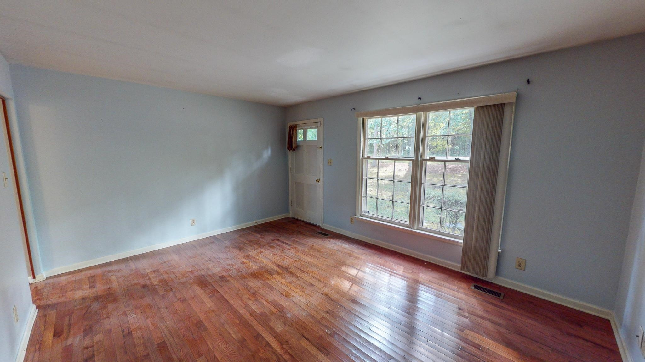 5516 Old NC 10 Durham, NC 27705 - Photo 2 of 26 an empty room with wooden floor and windows