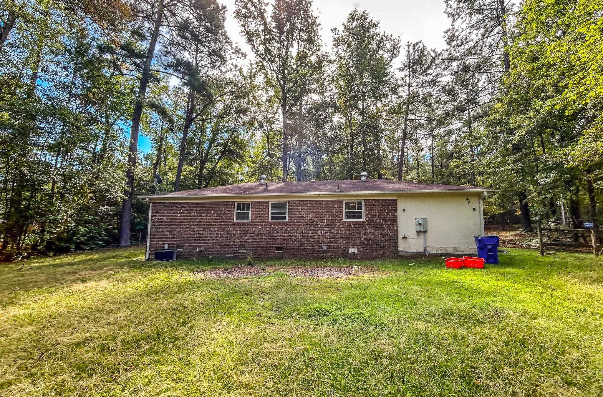 5516 Old NC 10 Durham, NC 27705 - Photo 6 of 26 a view of a house with a yard and trees