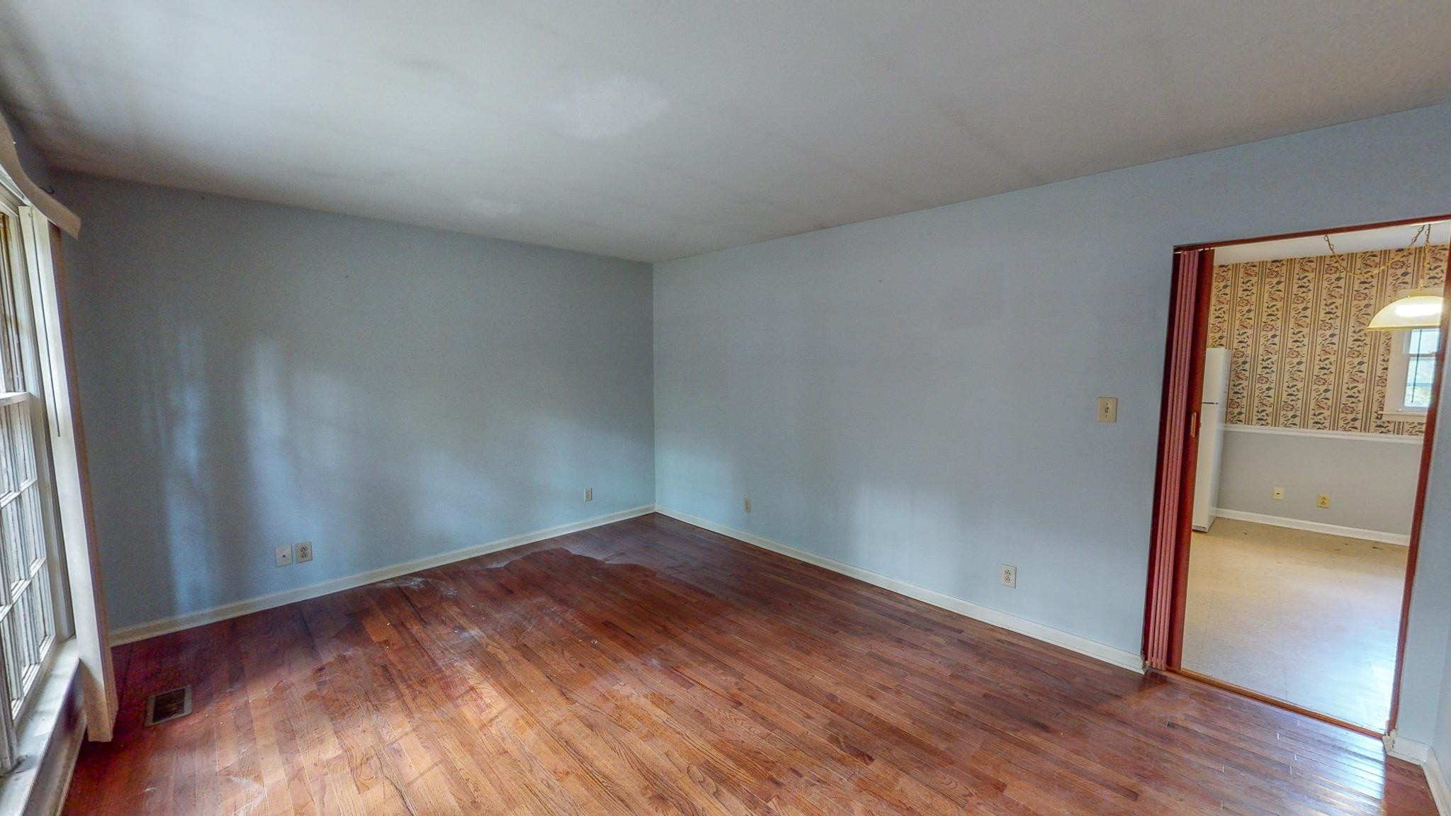 5516 Old NC 10 Durham, NC 27705 - Photo 8 of 26 an empty room with wooden floor and windows
