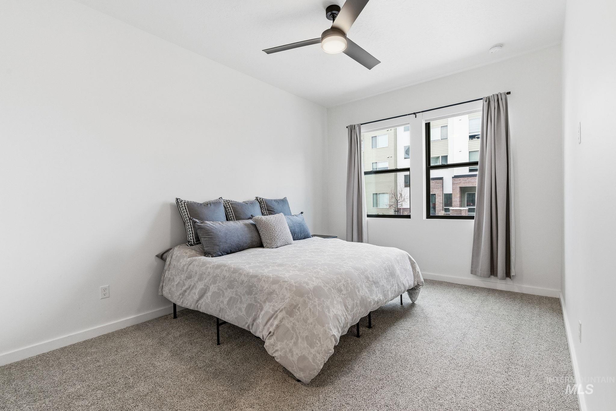 3928 East Haystack Street, Unit 107 Boise, ID 83716 - Photo 10 of 37 Bedroom with light carpet and a ceiling fan