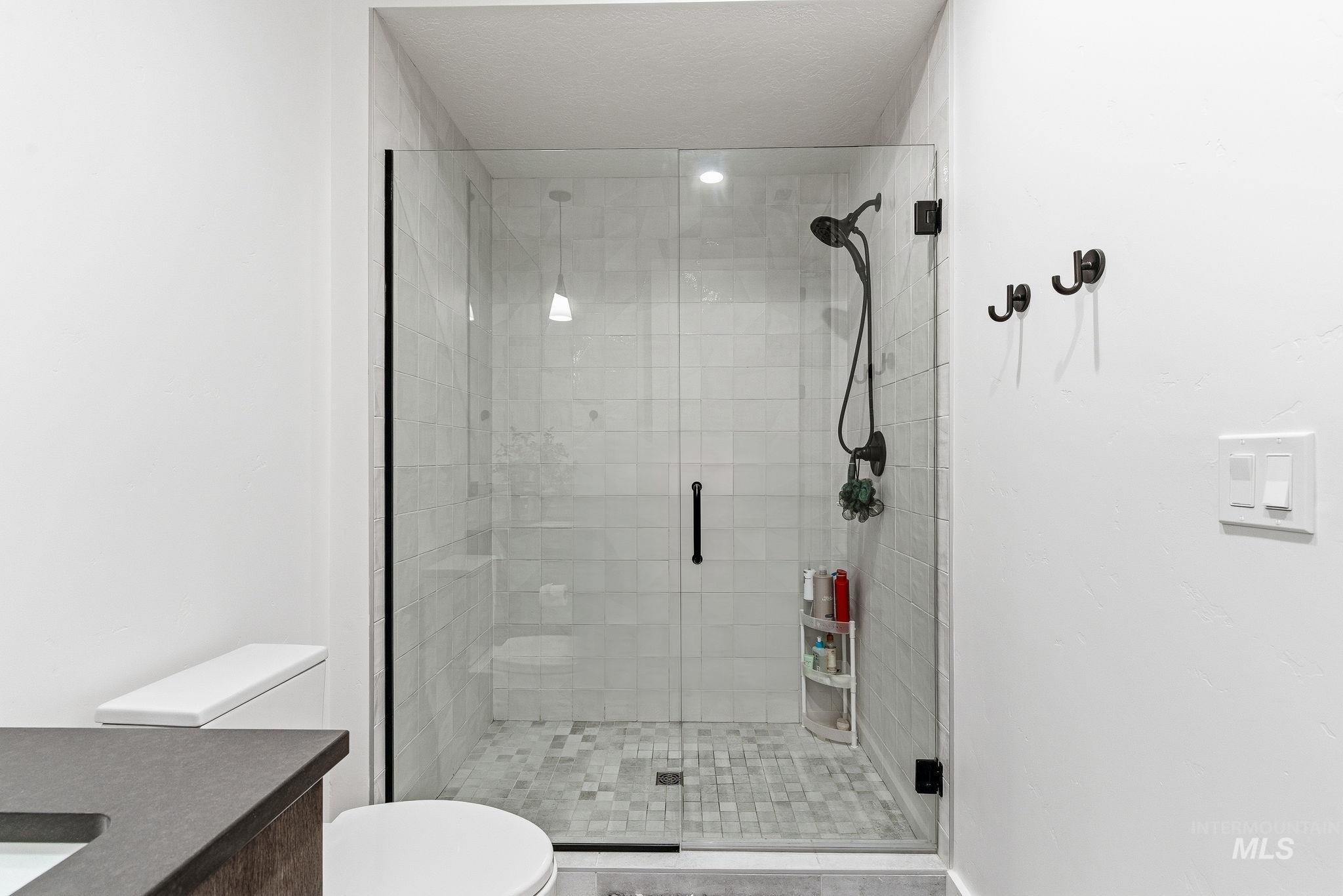 3928 East Haystack Street, Unit 107 Boise, ID 83716 - Photo 14 of 37 Bathroom with vanity and a stall shower