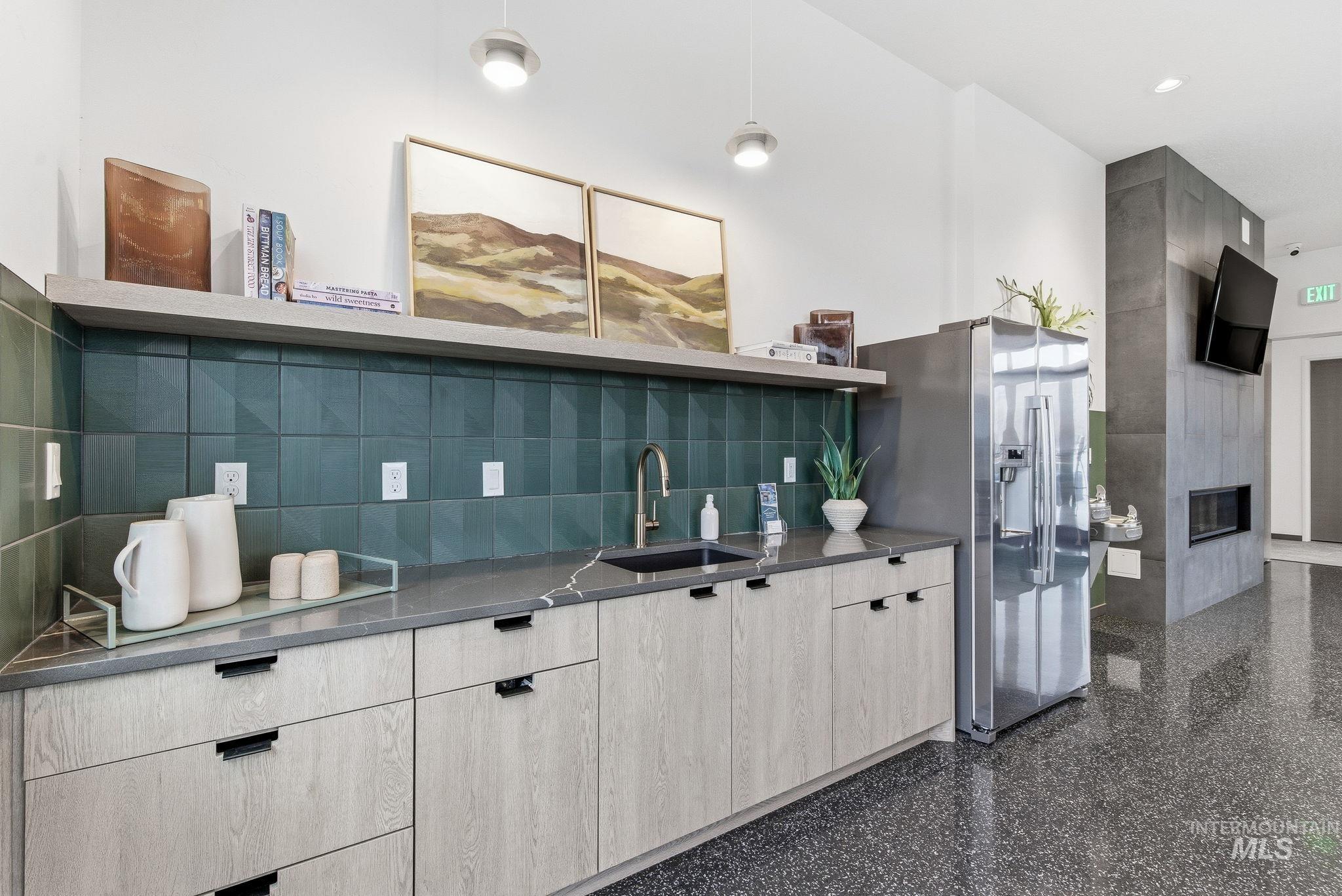 3928 East Haystack Street, Unit 107 Boise, ID 83716 - Photo 25 of 37 Kitchen featuring open shelves, modern cabinets, stainless steel refrigerator with ice dispenser, dark stone countertops, and a fireplace