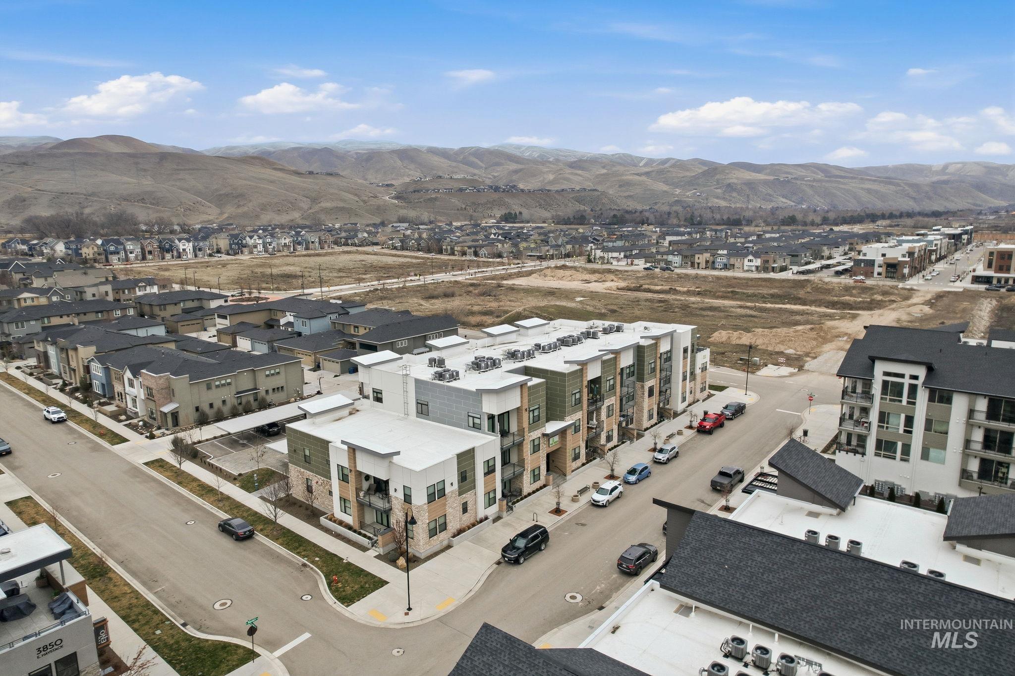 3928 East Haystack Street, Unit 107 Boise, ID 83716 - Photo 4 of 37 Aerial perspective of suburban area with a mountainous background