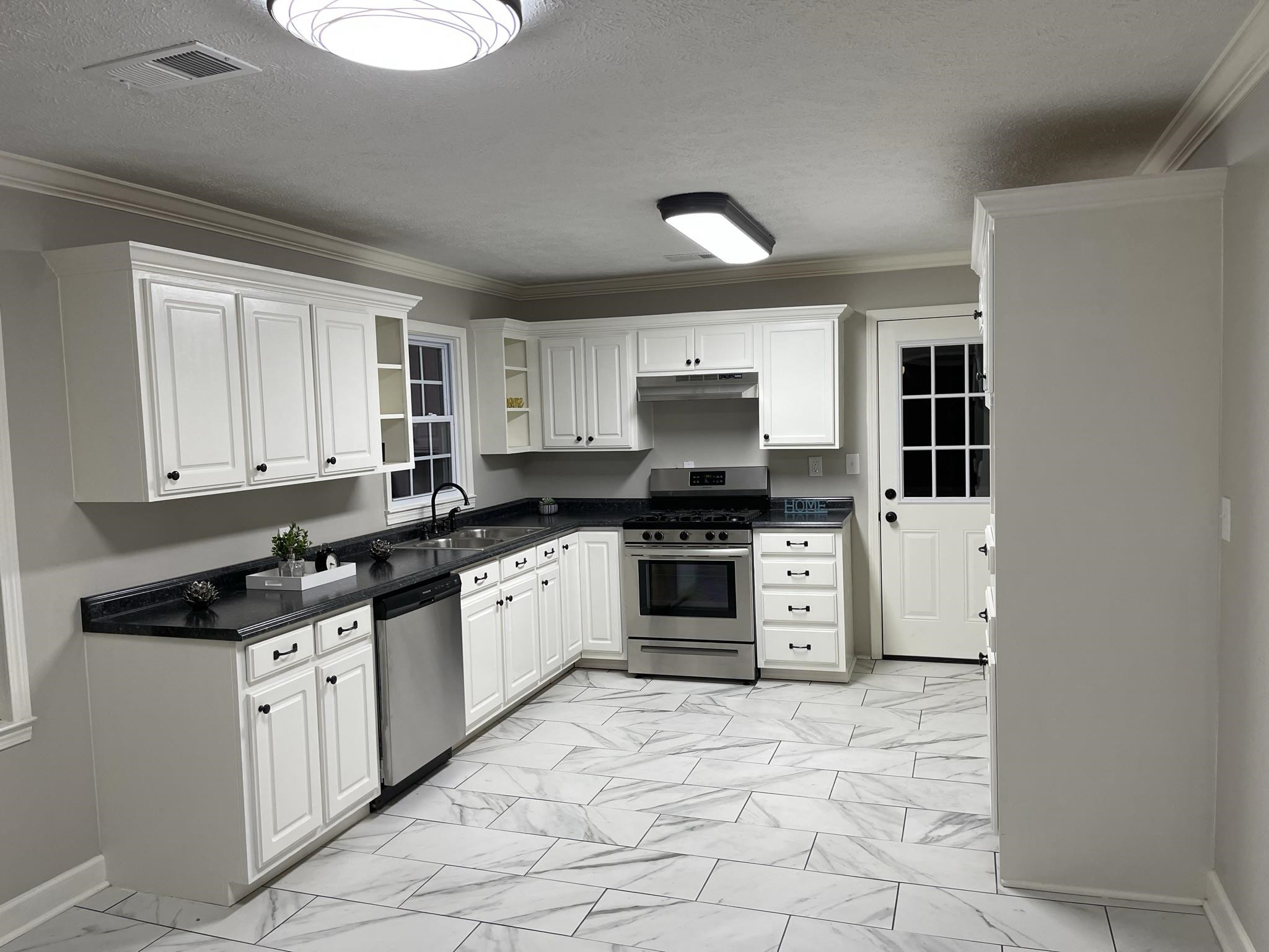 114 Old Denmark Road Jackson, TN 38301 - Photo 4 of 12 a kitchen with granite countertop a stove sink and cabinets