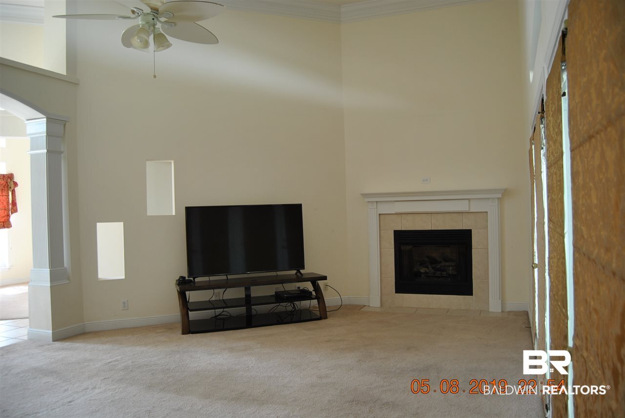 411 Juniper Creek Road Brewton, AL 36426 - Photo 19 of 35 Den has gas fire longs windows and doors to pool