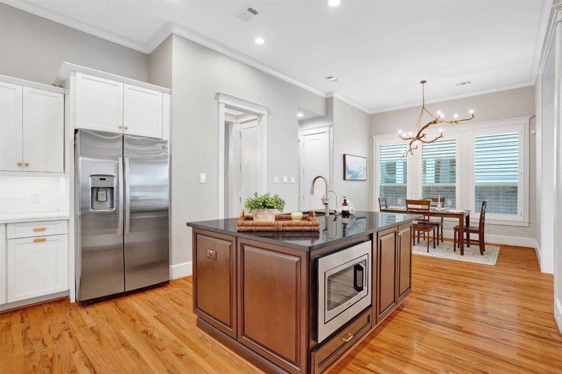 612 Rutland Street Houston, TX 77007 - Photo 17 of 45 Modern Efficiency. The oversized kitchen island is as functional as it is beautiful, featuring a large undermount sink and a discreet under-counter microwave.