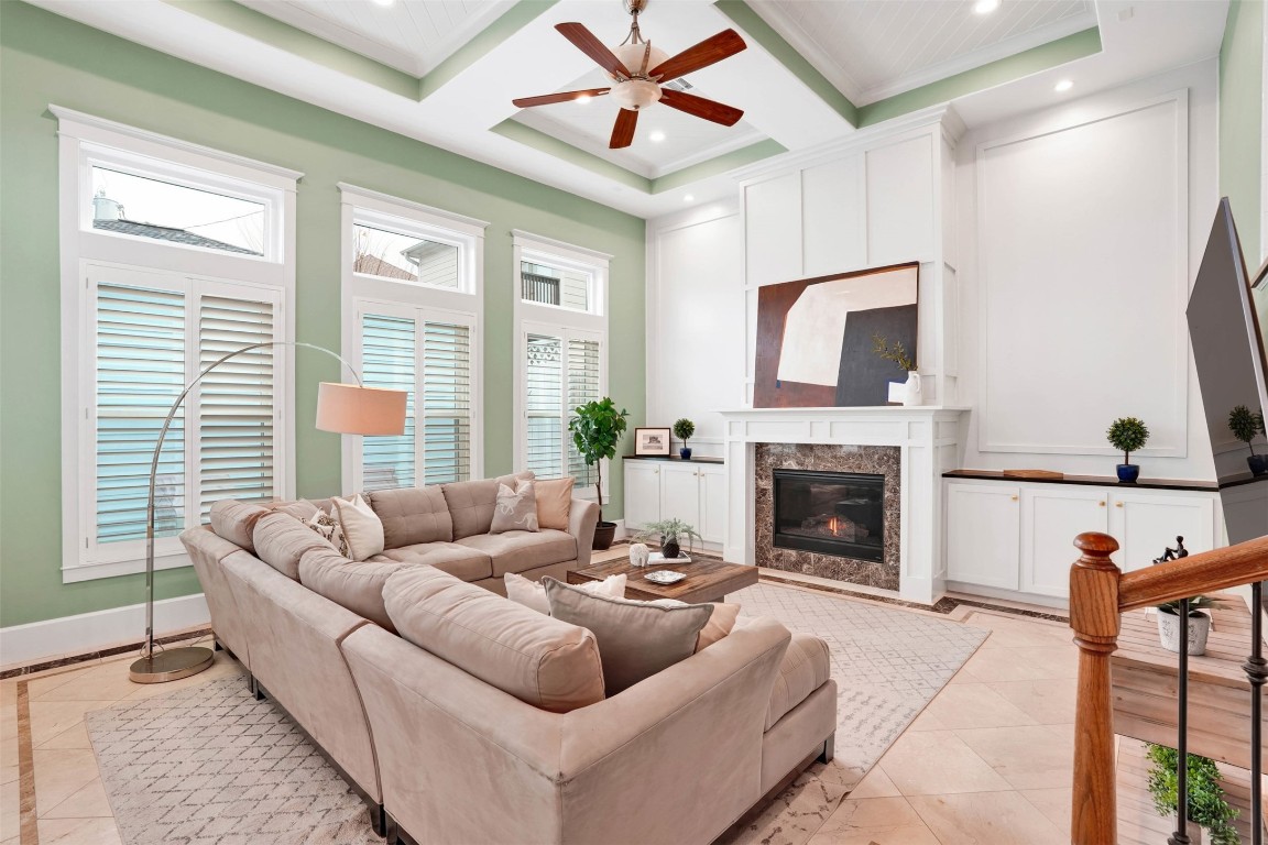 612 Rutland Street Houston, TX 77007 - Photo 20 of 45 Sophisticated Comfort. Custom built-ins and a classic fireplace anchor the room, offering both elegant storage and a warm focal point.