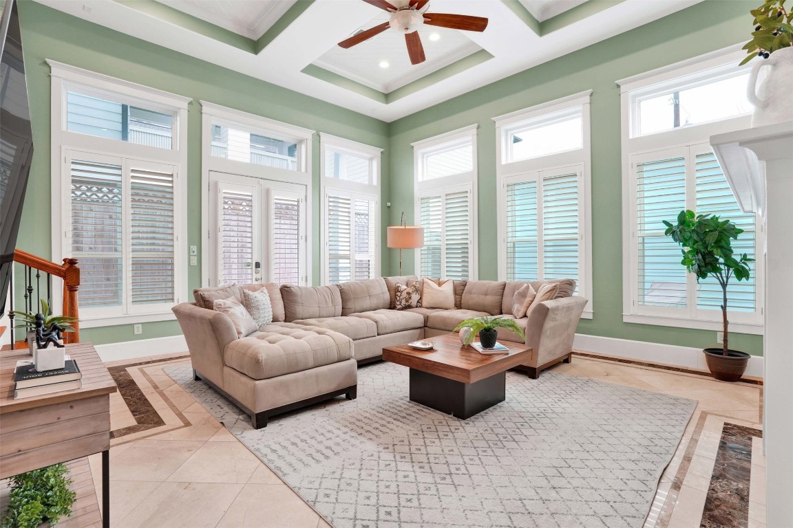 612 Rutland Street Houston, TX 77007 - Photo 21 of 45 A Quiet Sanctuary. Relax in a sun-drenched family room that stays perfectly peaceful thanks to energy-efficient triple-pane windows (2023). The view of the lush, low-maintenance turf backyard provides a serene backdrop to your daily life.