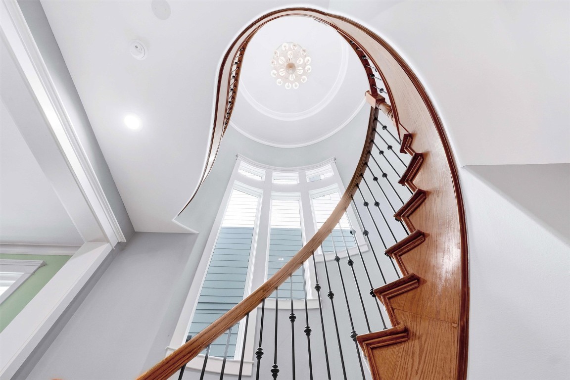 612 Rutland Street Houston, TX 77007 - Photo 3 of 45 A Grand Entrance. The home’s historic soul shines through this stunning curved staircase, framed by soaring ceilings and oversized windows create an immediate sense of scale and elegance.