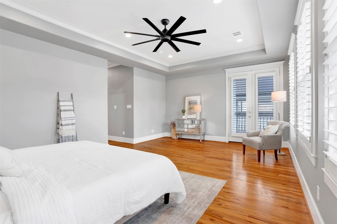 612 Rutland Street Houston, TX 77007 - Photo 35 of 45 Primary Suite with Private Balcony. Luxury meets fresh air. This expansive retreat features dedicated balcony access through French doors, offering a quiet, outdoor sanctuary tucked away at the back of the home.
