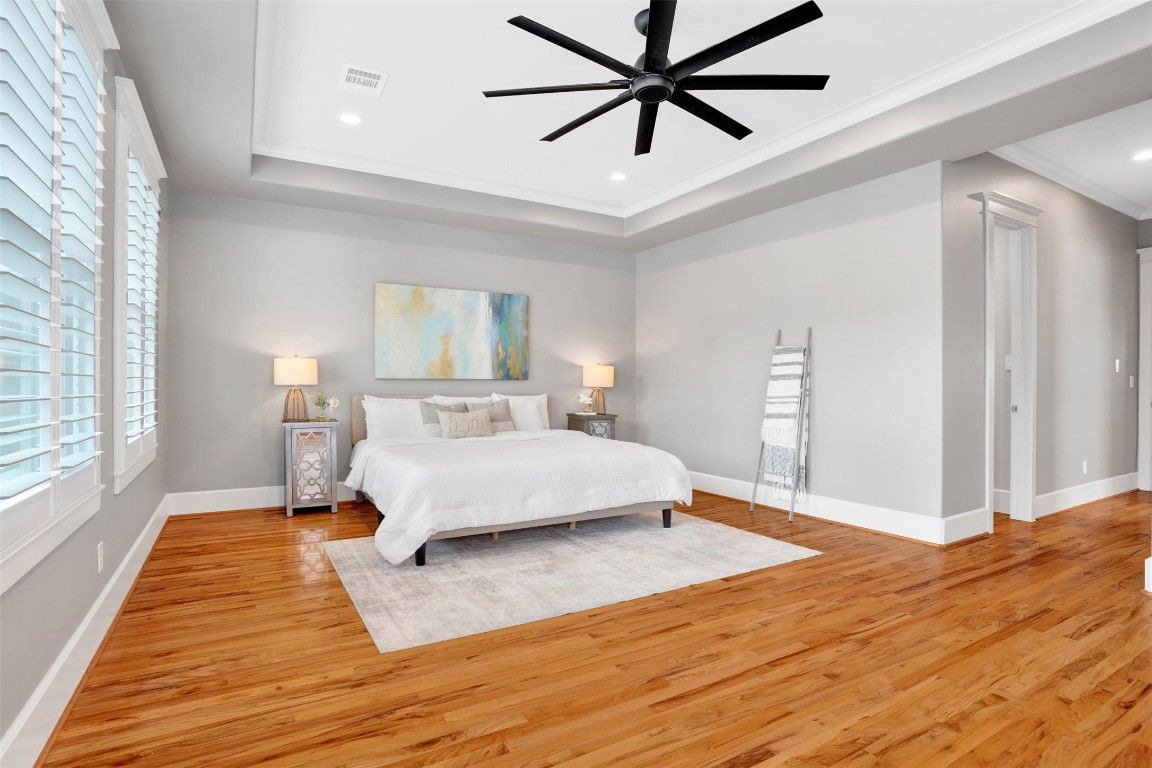 612 Rutland Street Houston, TX 77007 - Photo 36 of 45 Massive Scale, Superior Airflow. Highlighted by soaring ceilings and a statement-sized ceiling fan, the primary retreat is engineered for both style and comfort. A true sanctuary designed for the Houston climate.