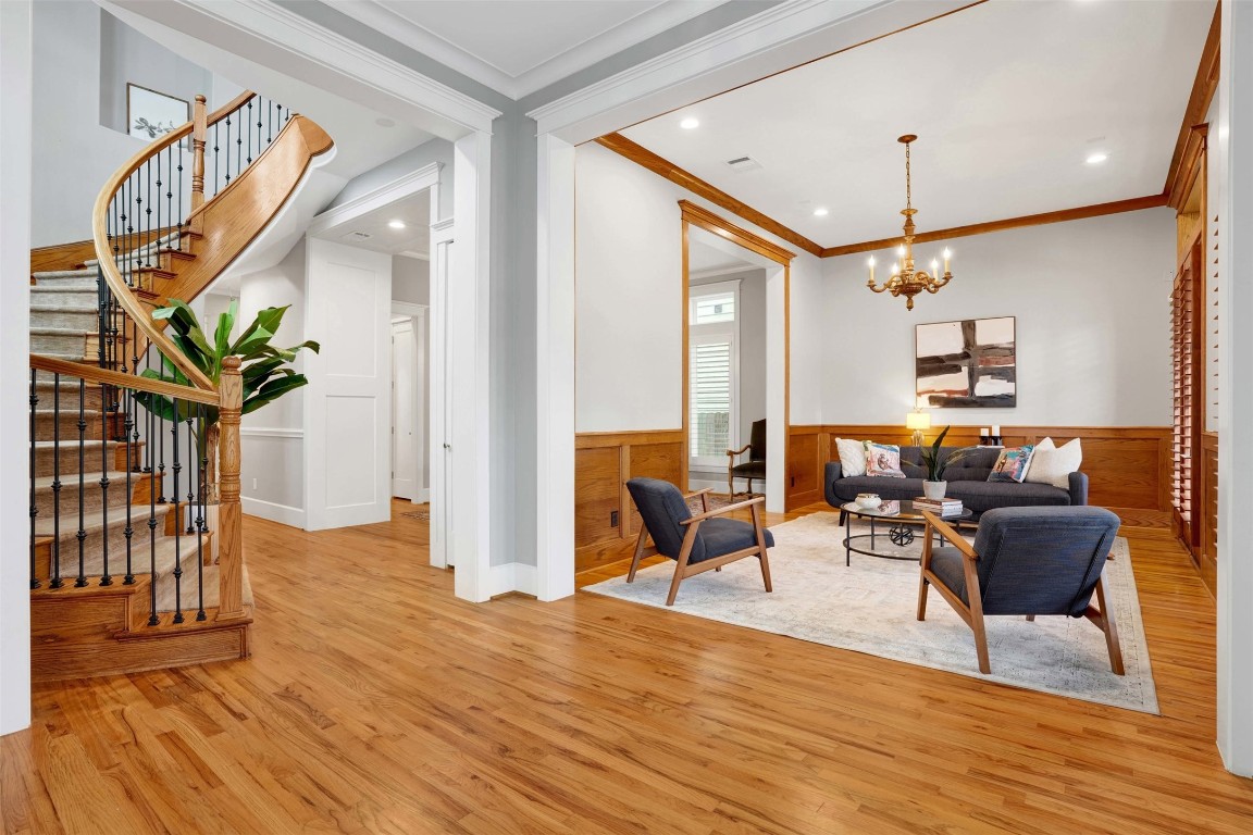 612 Rutland Street Houston, TX 77007 - Photo 8 of 45 Step into a home designed for impact. This welcoming entry showcases the dramatic architectural volume and natural light that define the interior, leading your eye through the formal parlor toward the heart of the home.