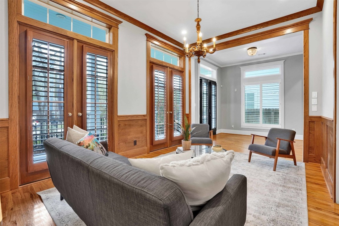 612 Rutland Street Houston, TX 77007 - Photo 10 of 45 Light-Filled Elegance. Massive windows flood the parlor with natural light, highlighting the seamless flow into the formal dining area. This versatile space offers a sophisticated retreat for hosting guests or enjoying a quiet afternoon in the heart of the Heights.