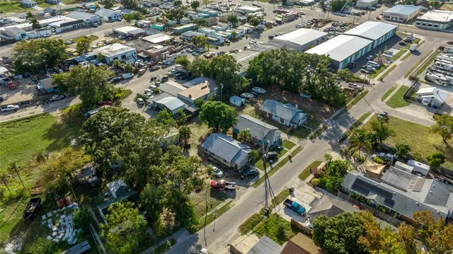 an aerial view of residential houses with green space