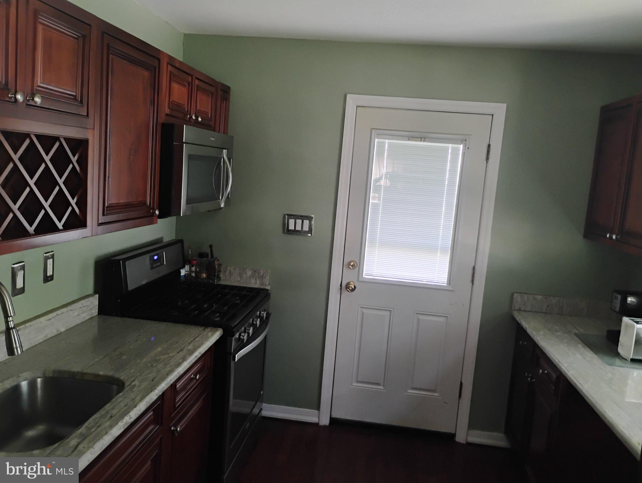 3908 Lantern Drive Silver Spring, MD 20902 - Photo 3 of 15 a kitchen with a sink and cabinets