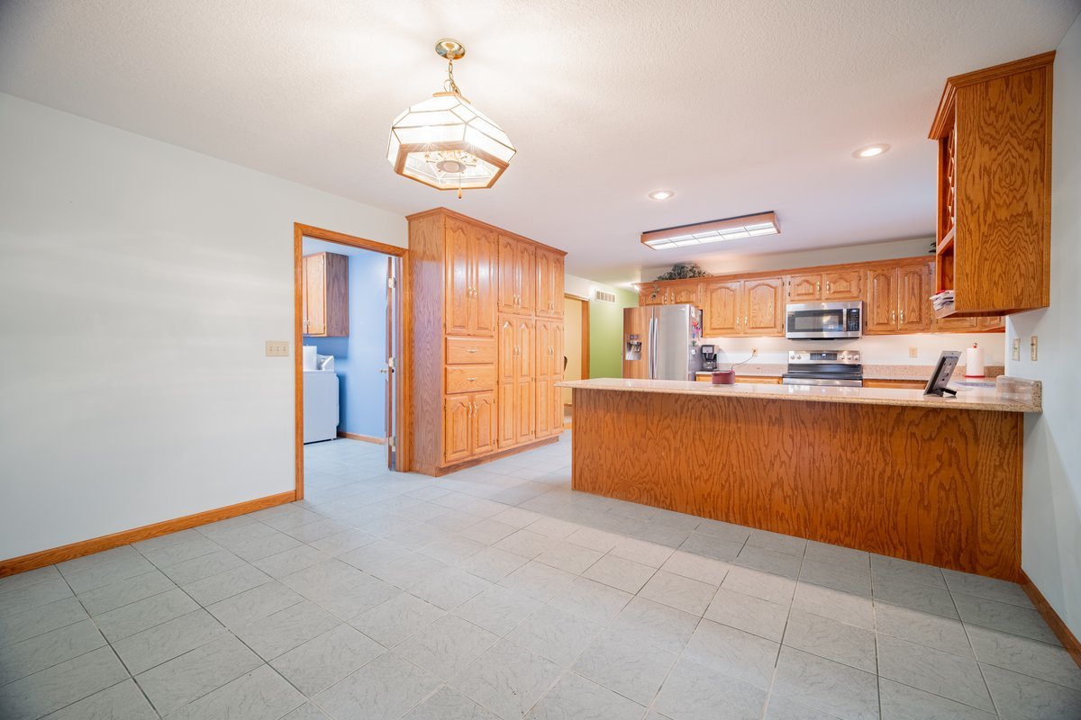 8401 Idlewood Road Clinton, IL 61727 - Photo 11 of 42 a kitchen with stainless steel appliances granite countertop a sink and cabinets