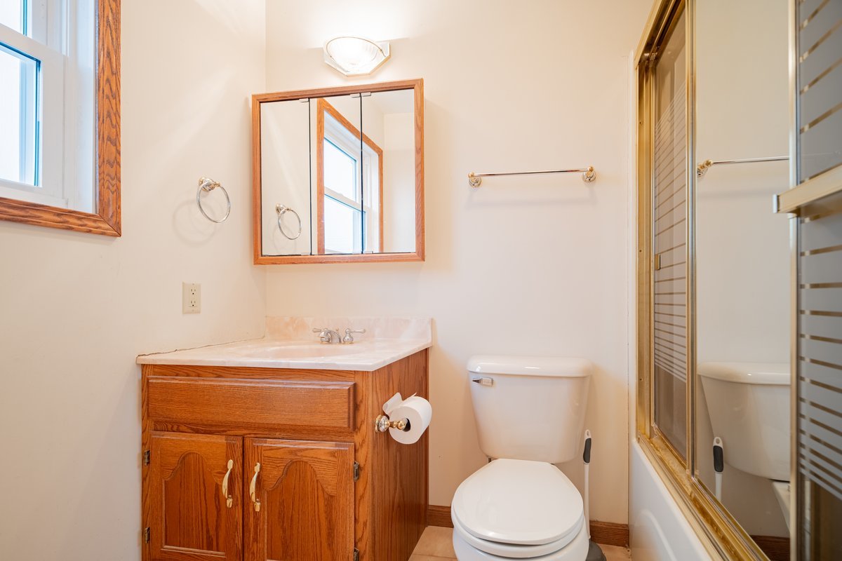 8401 Idlewood Road Clinton, IL 61727 - Photo 17 of 42 a white toilet sitting next to a bathroom sink