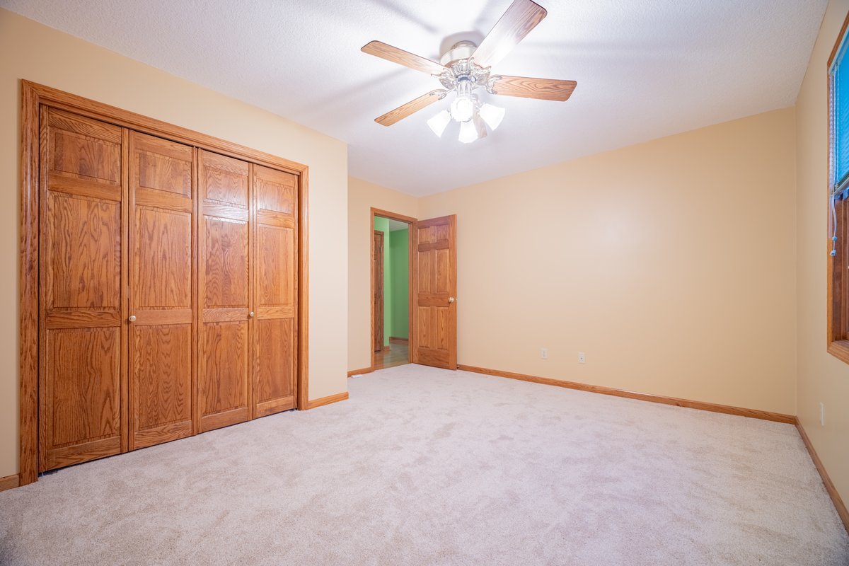 8401 Idlewood Road Clinton, IL 61727 - Photo 18 of 42 an empty room with chandelier fan