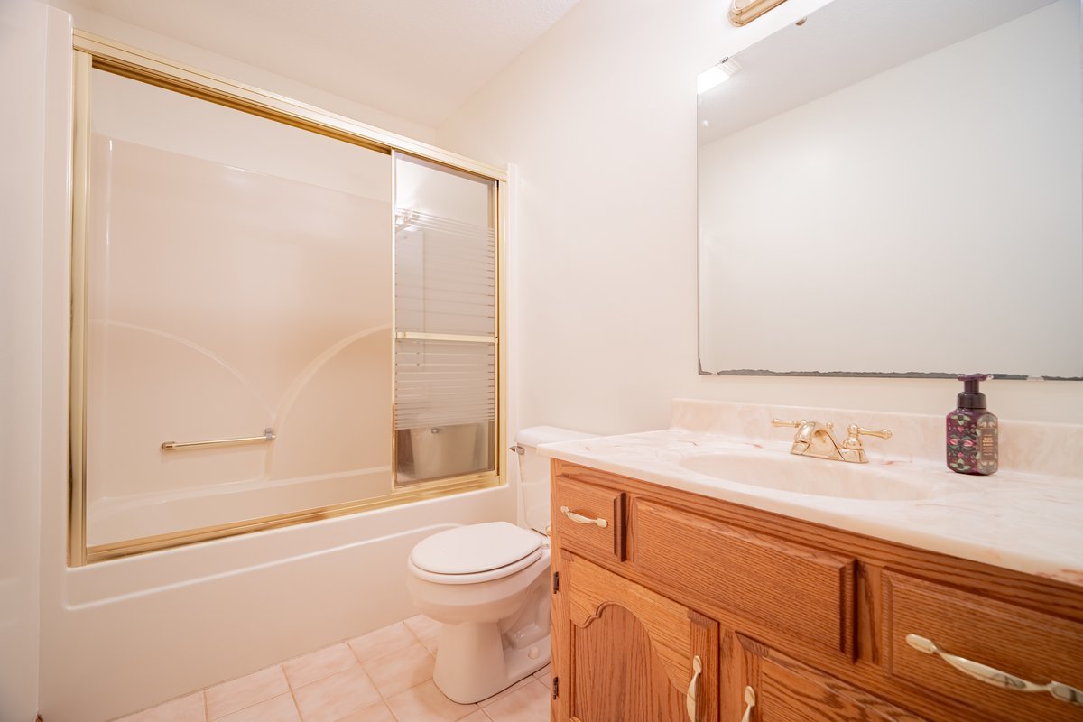 8401 Idlewood Road Clinton, IL 61727 - Photo 19 of 42 a bathroom with a sink a toilet and shower