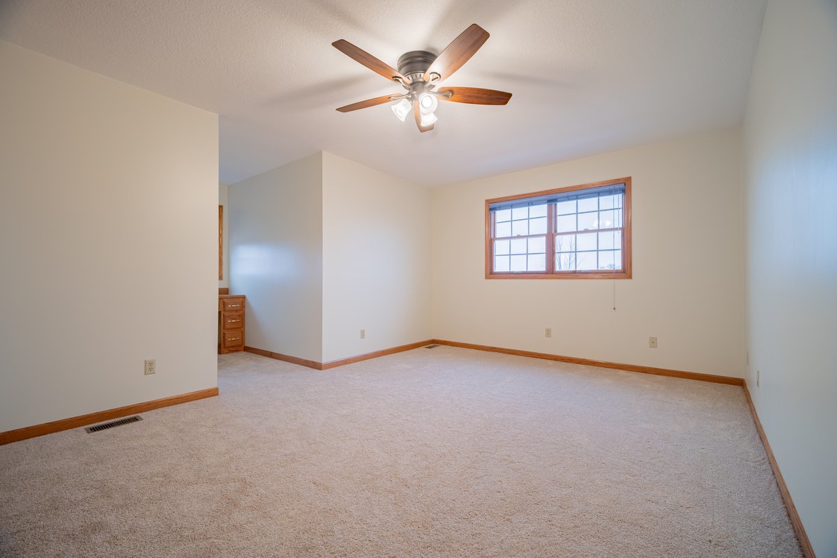 8401 Idlewood Road Clinton, IL 61727 - Photo 21 of 42 an empty room with ceiling fan and window