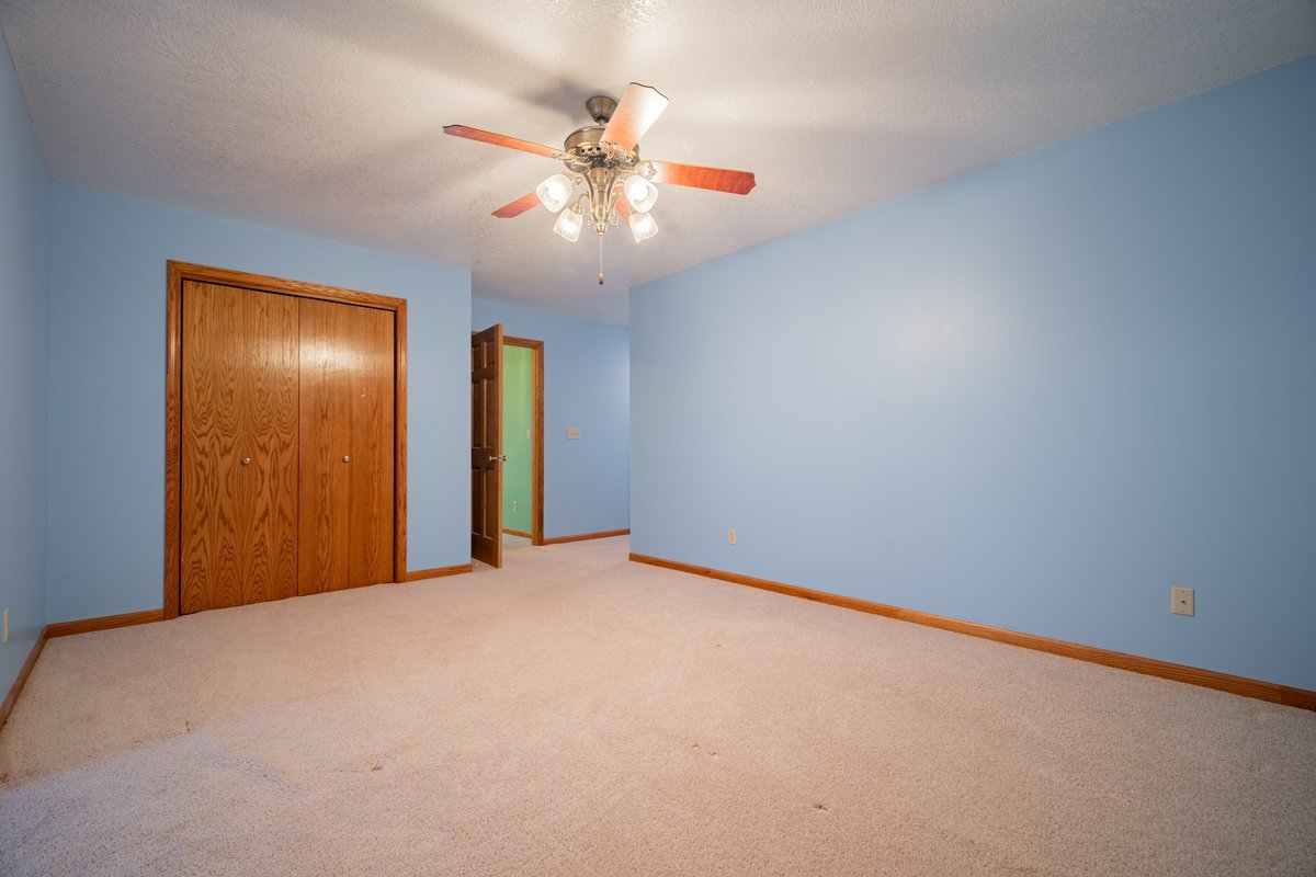 8401 Idlewood Road Clinton, IL 61727 - Photo 24 of 42 a view of an empty room with a chandelier fan