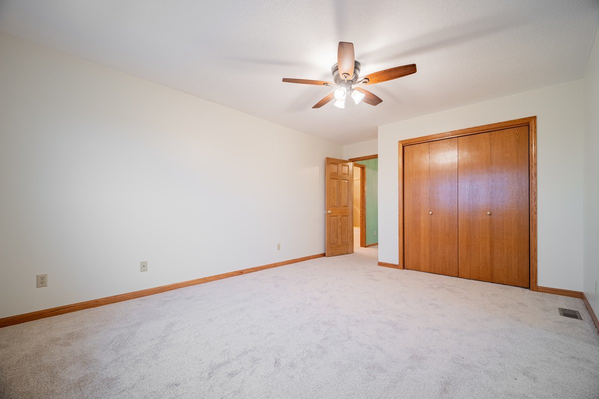 8401 Idlewood Road Clinton, IL 61727 - Photo 25 of 42 a view of an empty room with a ceiling fan