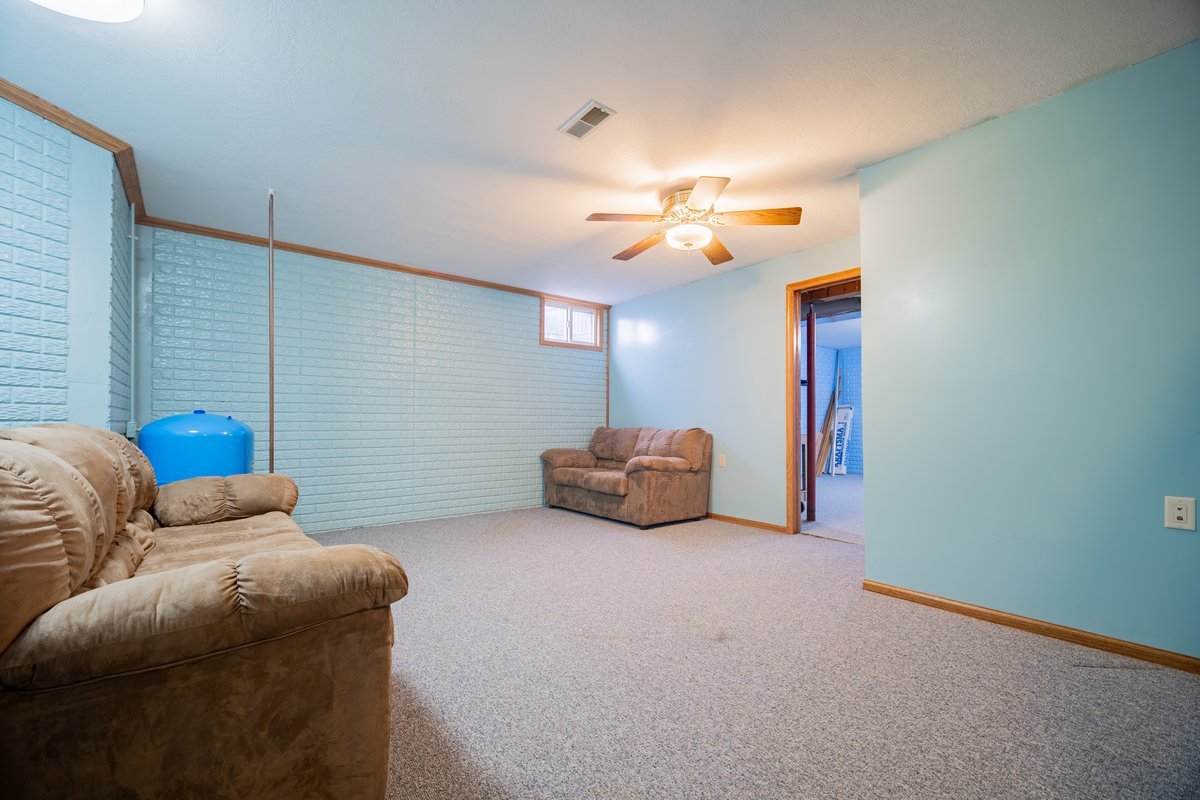 8401 Idlewood Road Clinton, IL 61727 - Photo 27 of 42 a living room with furniture and a chandelier