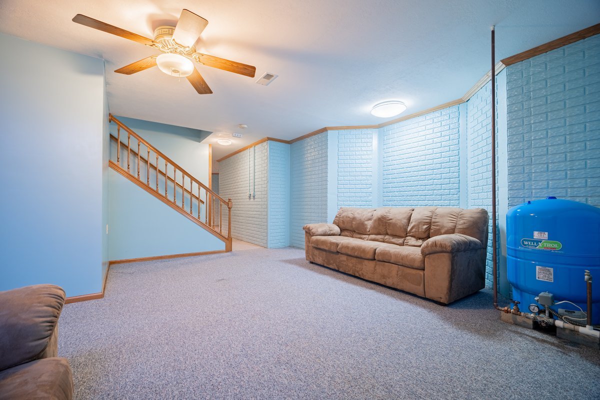 8401 Idlewood Road Clinton, IL 61727 - Photo 28 of 42 a living room with furniture and a chandelier