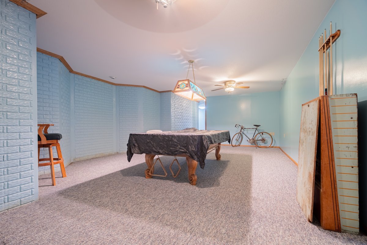 8401 Idlewood Road Clinton, IL 61727 - Photo 31 of 42 a living room with furniture and a chandelier