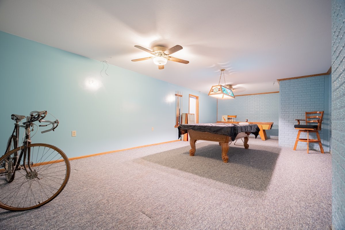 8401 Idlewood Road Clinton, IL 61727 - Photo 32 of 42 a living room with furniture and a chandelier
