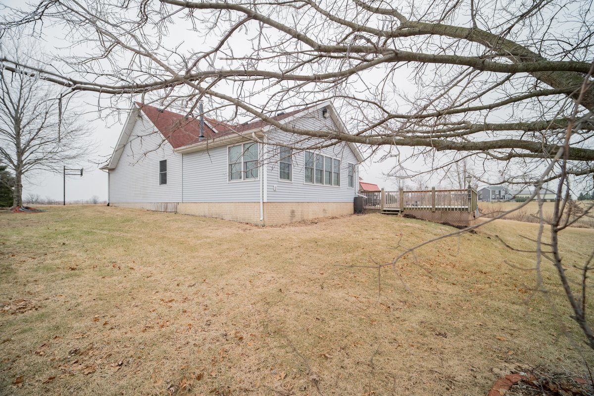 8401 Idlewood Road Clinton, IL 61727 - Photo 38 of 42 a white house that has a tree in front of it