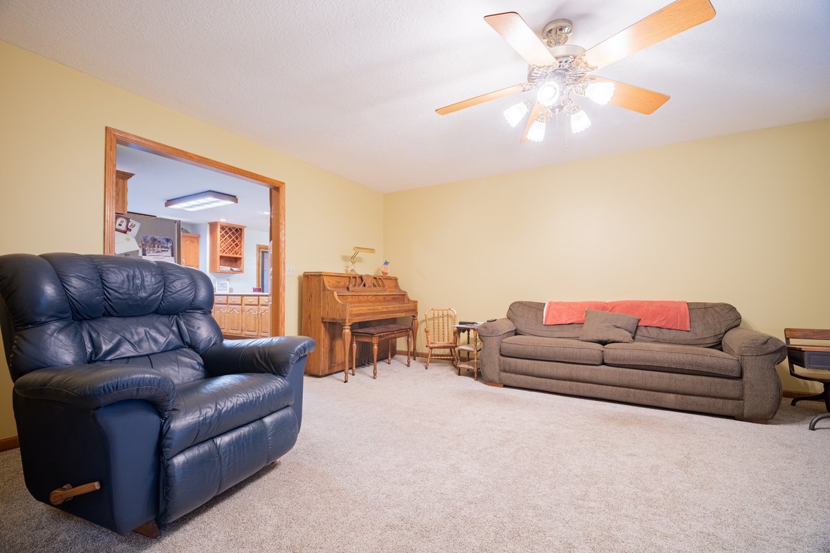8401 Idlewood Road Clinton, IL 61727 - Photo 6 of 42 a living room with furniture and a chandelier
