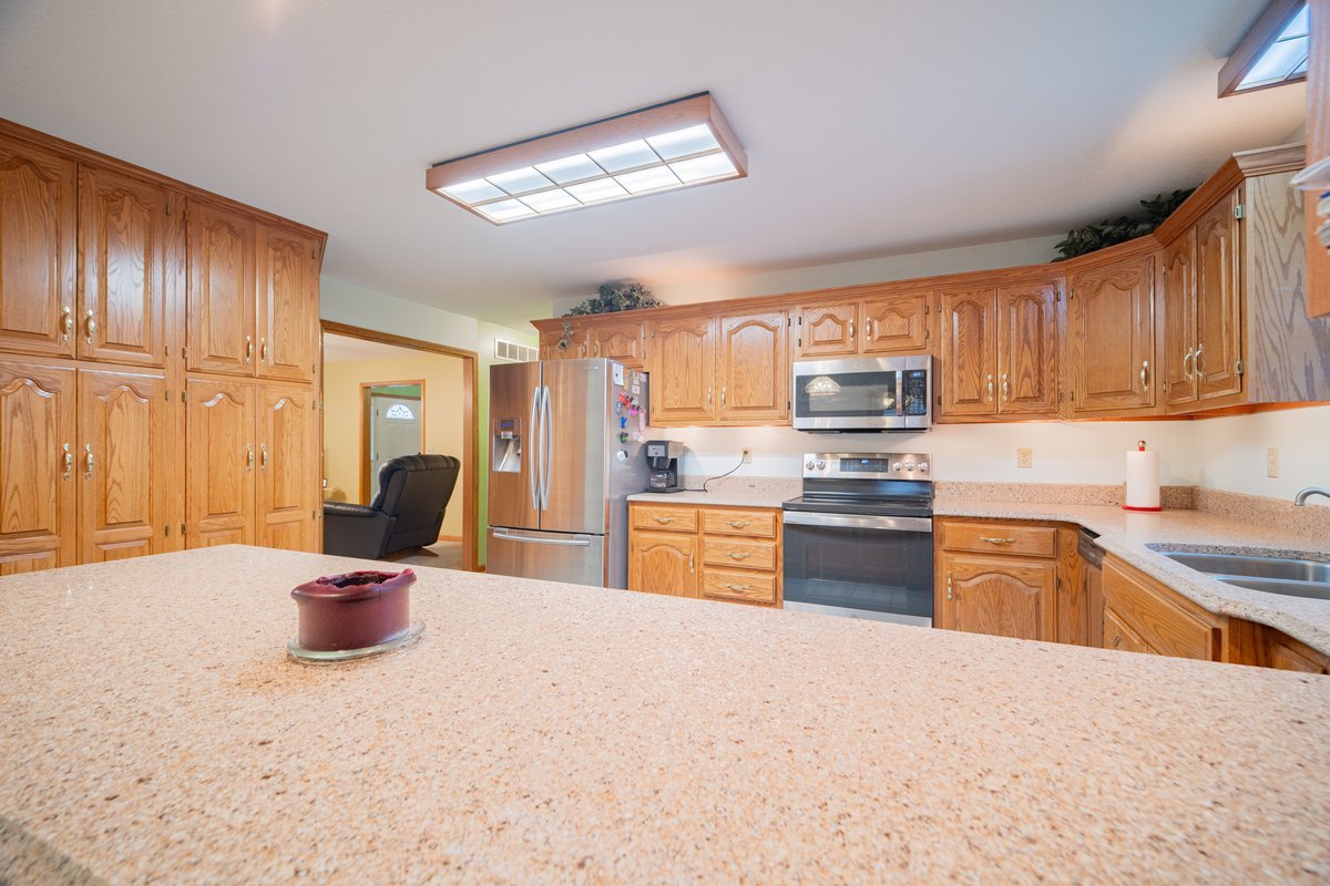 8401 Idlewood Road Clinton, IL 61727 - Photo 7 of 42 a kitchen with a refrigerator and a sink