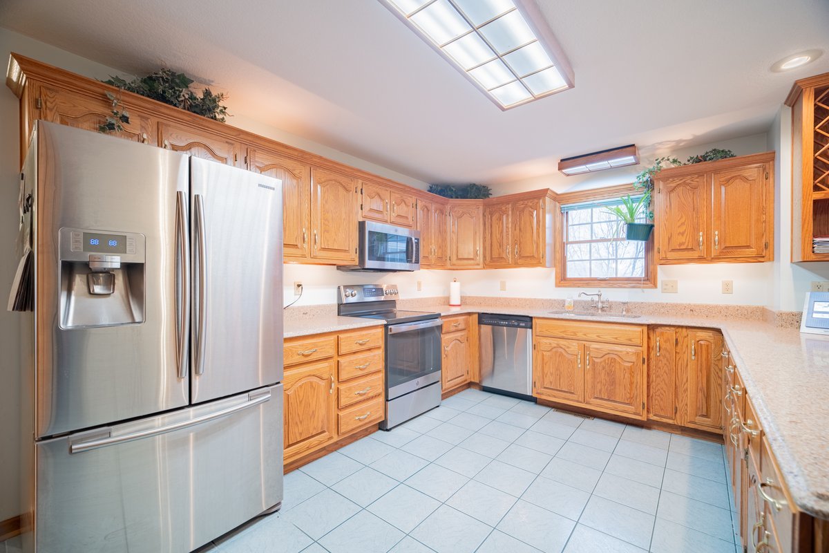 8401 Idlewood Road Clinton, IL 61727 - Photo 9 of 42 a kitchen with stainless steel appliances granite countertop a refrigerator sink and cabinets