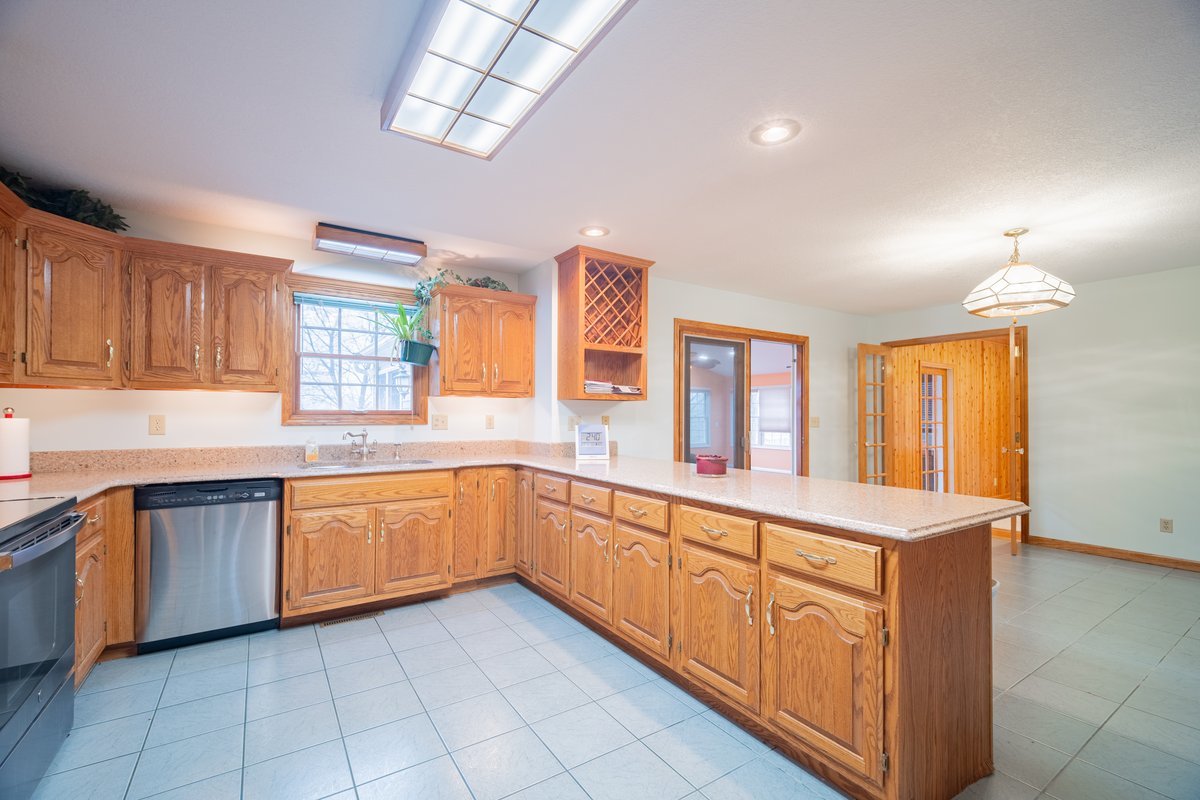 8401 Idlewood Road Clinton, IL 61727 - Photo 10 of 42 a large kitchen with stainless steel appliances granite countertop a sink and cabinets