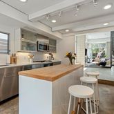 a kitchen with stainless steel appliances kitchen island granite countertop a sink and cabinets