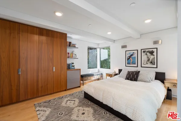 a bedroom with a large bed and a window