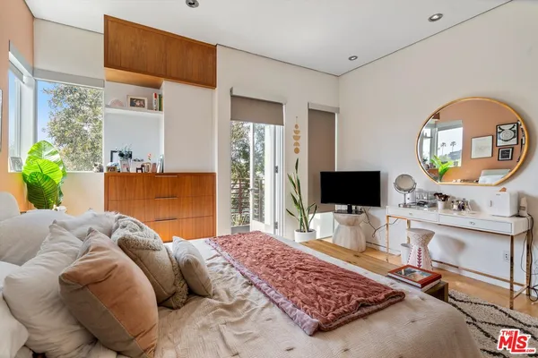 a bedroom with a bed and a flat screen tv