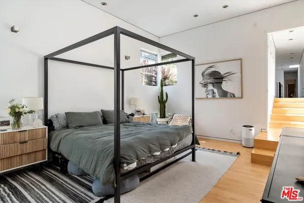 a bedroom with a large bed and a window