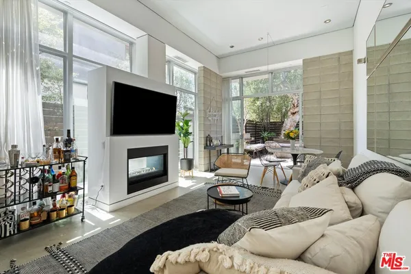 a living room with furniture fireplace and a flat screen tv