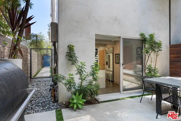 a dinning table and chairs in patio of the house
