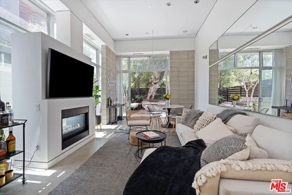 a living room with furniture a fireplace and a flat screen tv