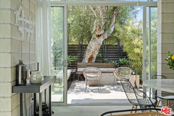 a view of a patio with couches chairs and potted plants