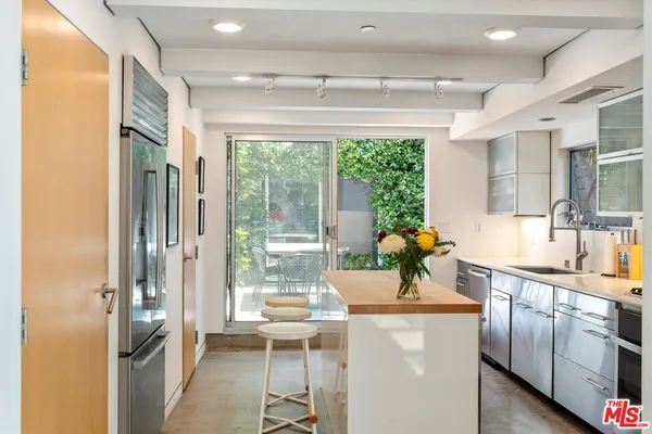 a kitchen with stainless steel appliances a sink and a large window