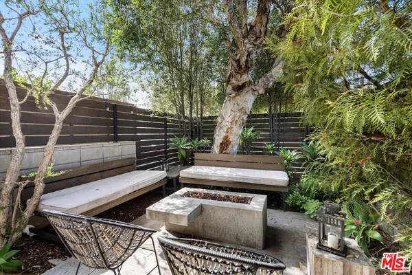 a backyard of a house with outdoor seating